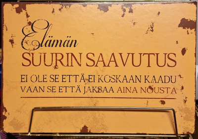 Elämän suurin saavutus -kyltti