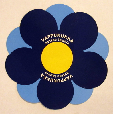 Vappukukka auttaa lapsia tarra