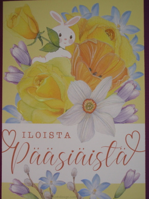 Katri Kuusela pupu kurkistaa kukkien keskeltä