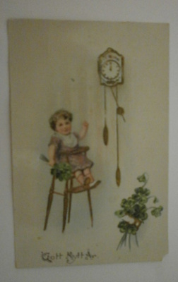 Lapsi, kello ja neliapiloita, Uuden Vuoden kortti, p. 1922