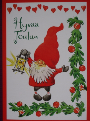Iloinen tonttu lyhty kädessä