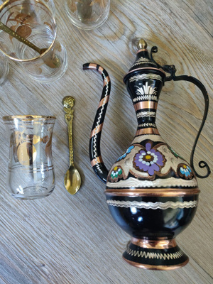 Koristeellinen vintage kuparikannu ja teelasit