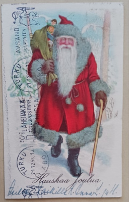 Joulupukki lahjasäkki selässä, keppi kädessään, p. 1955