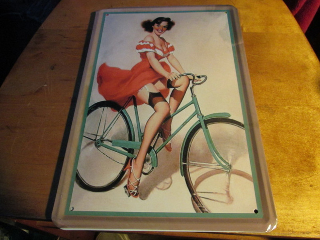 Peltikyltti Pin-Up-tyttö ja polkupyörä