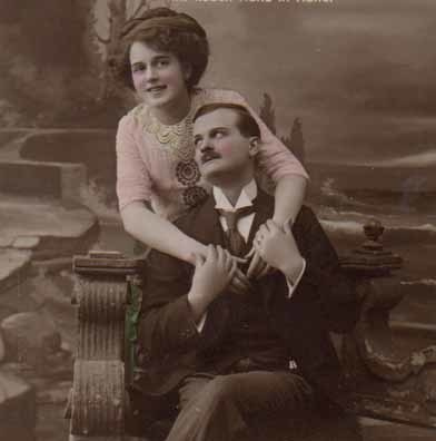 RAKKAUS / Istuva mies pitää kaunista tyttöä käsistä. 1900-l.
