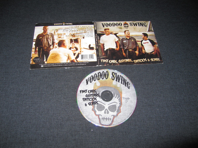 Voodoo Swing ?– Fast Cars, Guitars, Tattoos & Scars