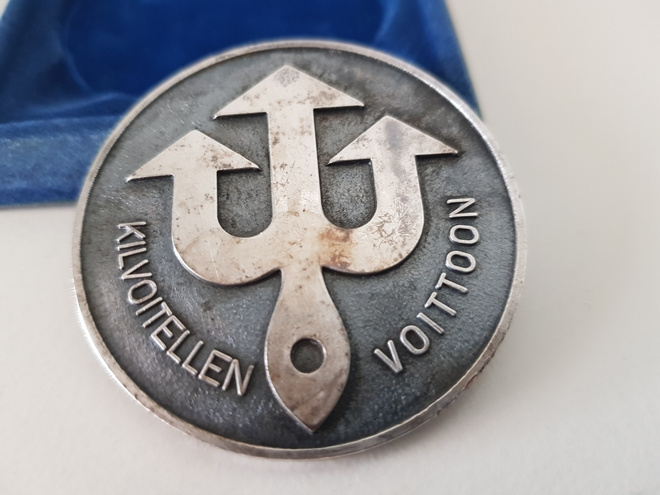 '' Kilvoitellen voittoon '' hopeanvärinen mitali