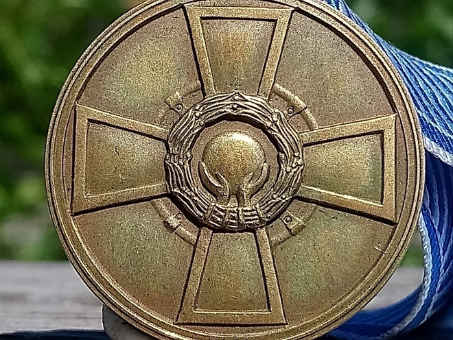 Suomen Urheilun Ronssinen ansiomerkki. Halkaisija - 31 mm.
