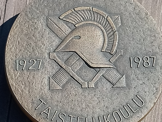 Taistelukoulu 1927 - 1987. Valmistajan leimalla. Suunnitteli