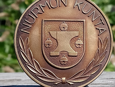 Nurmon Kunta Ronssivärinen merkki. Halkaisija - 49 mm.