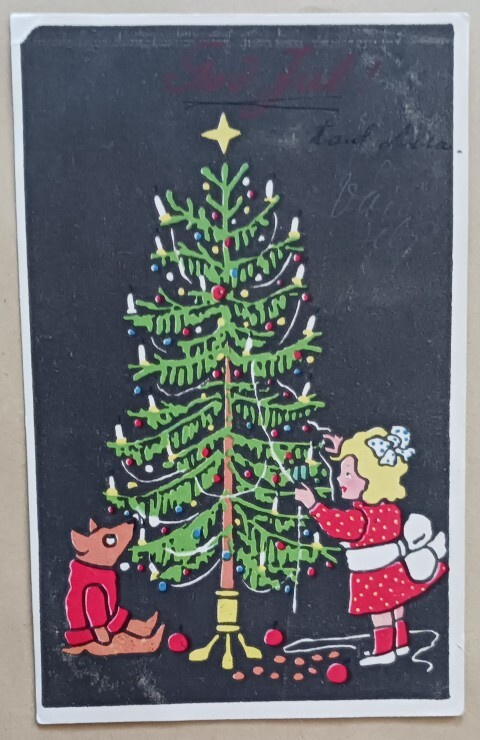 Lapsi ja koira koristelevat joulukuusta, p. 1933