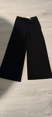 Uudet mustat neulehousut S/M