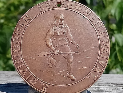 Pronssivärinen 5 Divisioonan merkki. Halkaisija - 59 mm.