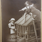 Poika temppuilee kanahäkin päällä, tyttö tuo ruokaa, p. 1924 - pikkukuva 1