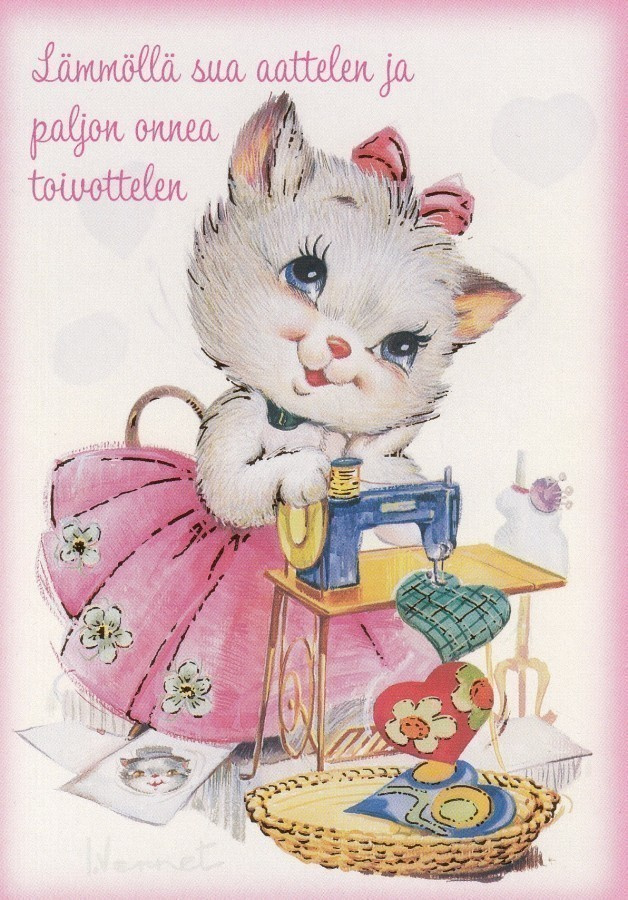 Kissa onnittelee ja ompelee sydämiä
