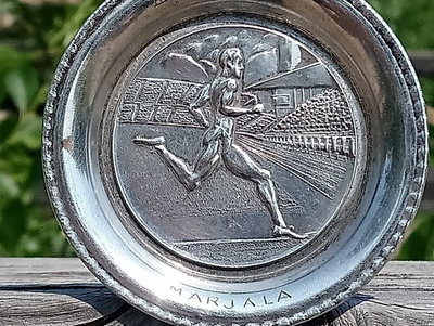 Paavo Nurmen kuvalla varustettu Hopeavärinen lautanen. Halka