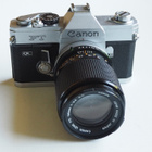 Canon FT QL kamera + Canon FD 135 mm. + ym.postikuluineen. - pikkukuva 1