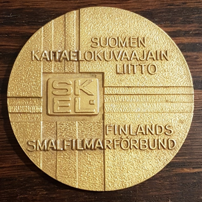 SUOMEN KAITAELOKUVAAJAINLIITTO MITALI