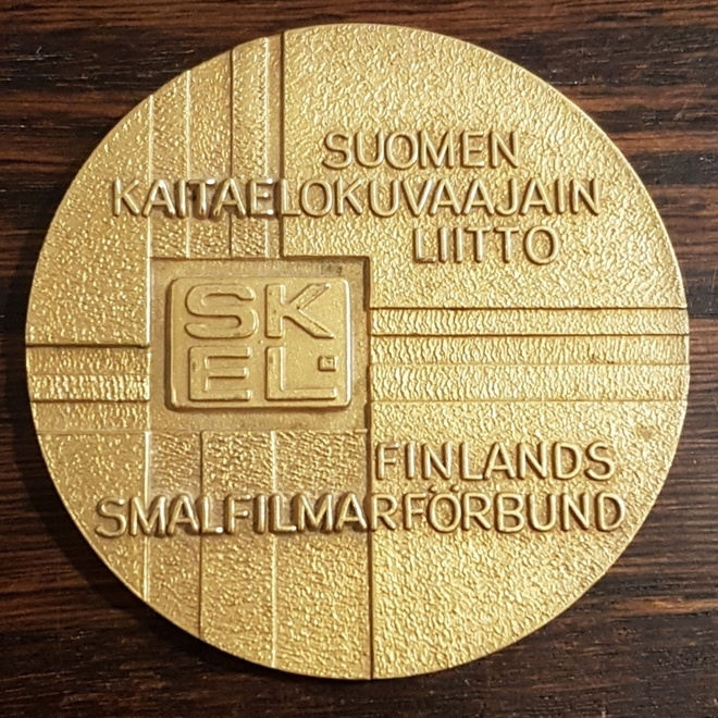 SUOMEN KAITAELOKUVAAJAINLIITTO MITALI